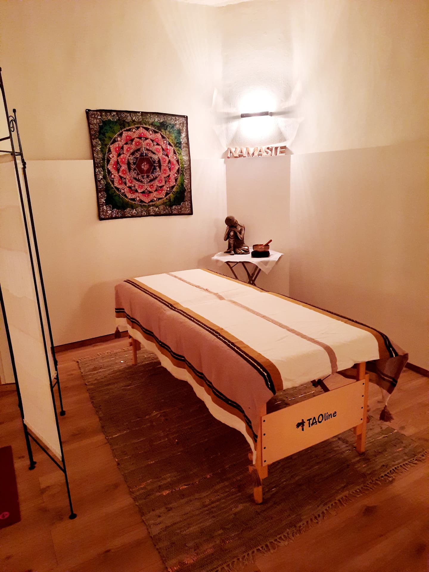 Espace massage du Centre Shambala : table de massage, mandala et lumière douce